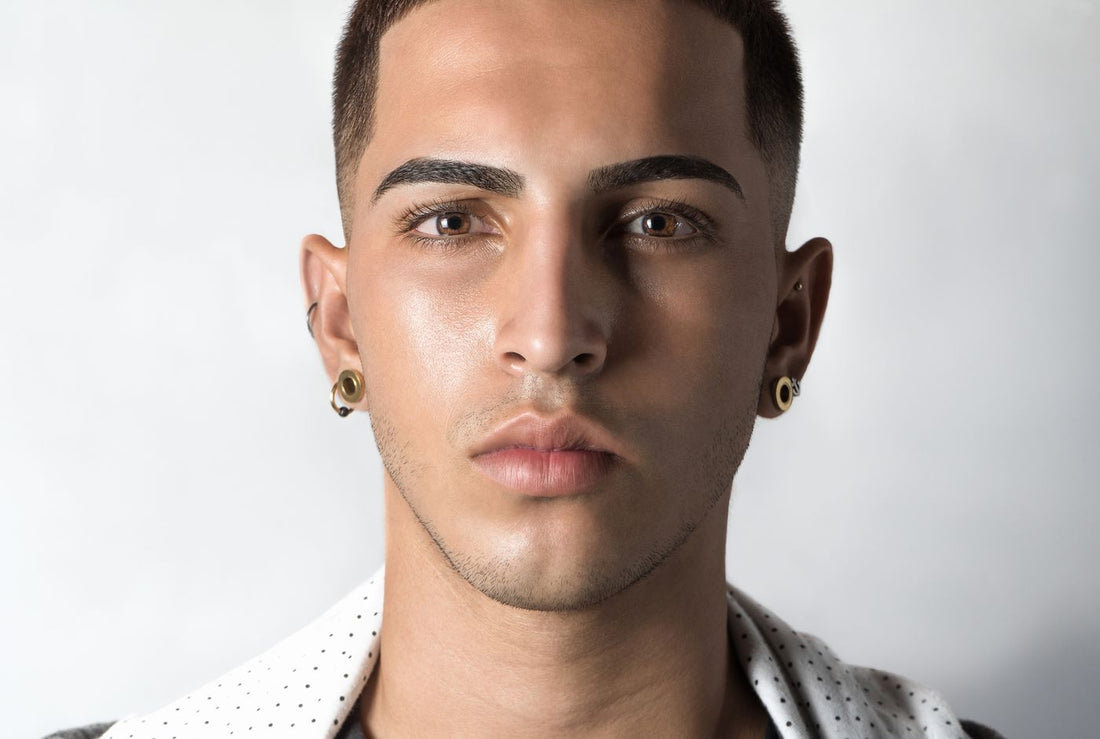 Clean portrait of a model in white layers wearing small ear jewelry