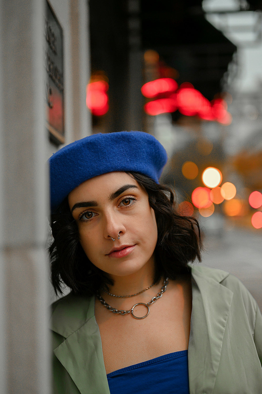 Street-style portrait with blue beret and nose hoop jewelry