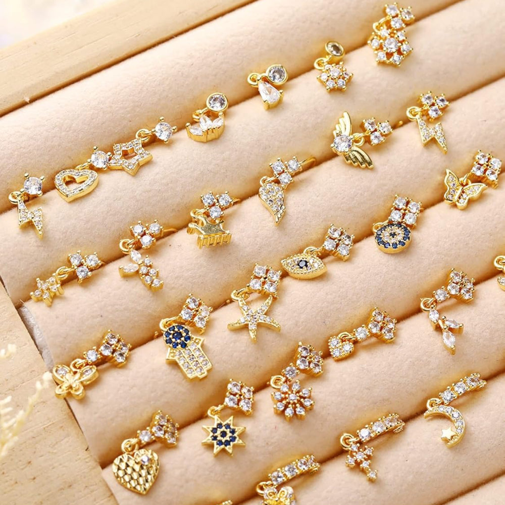 Gold dangle nose ring set with star heart leaf and flower details