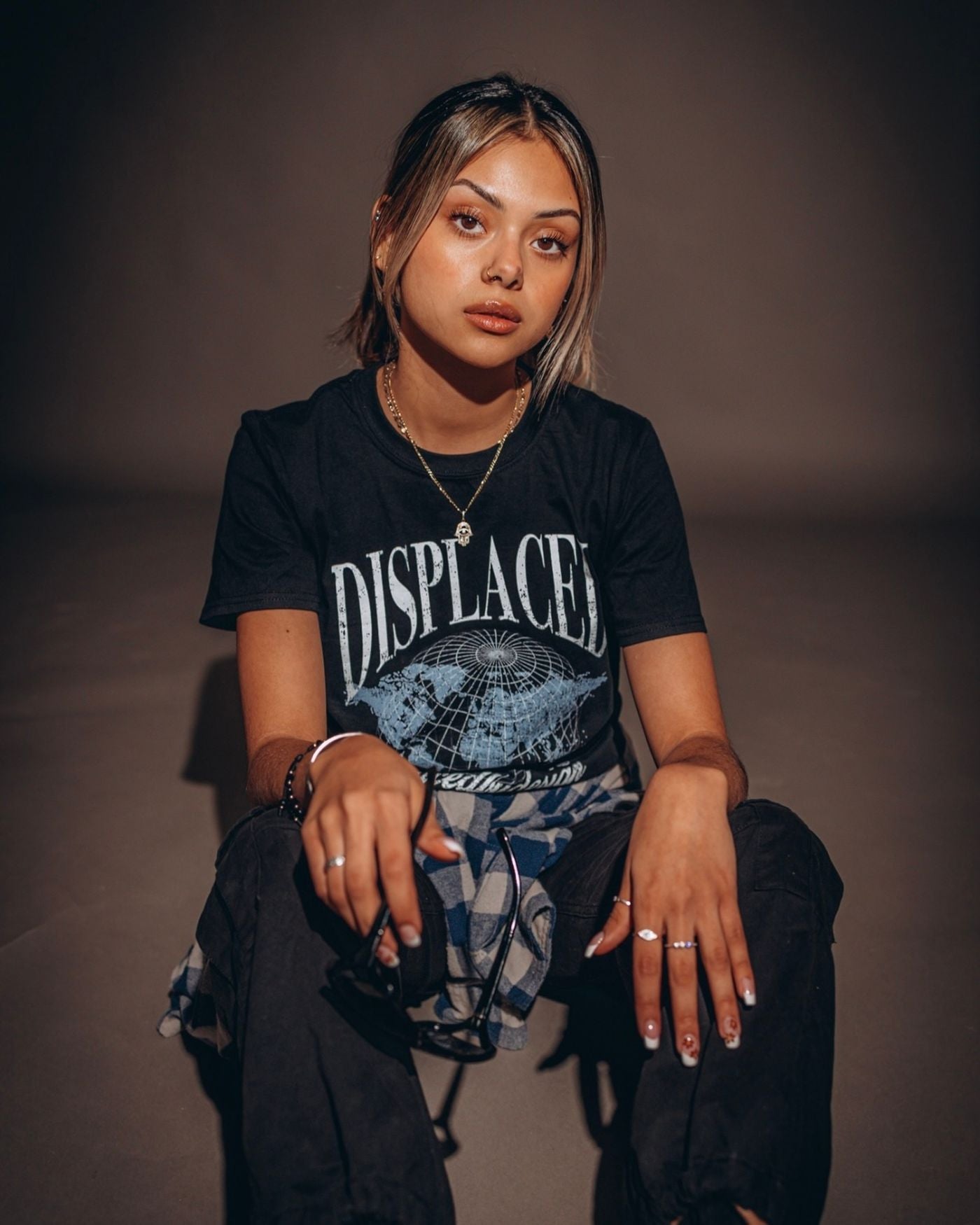 Streetwear model in a graphic tee with layered jewelry and casual styling