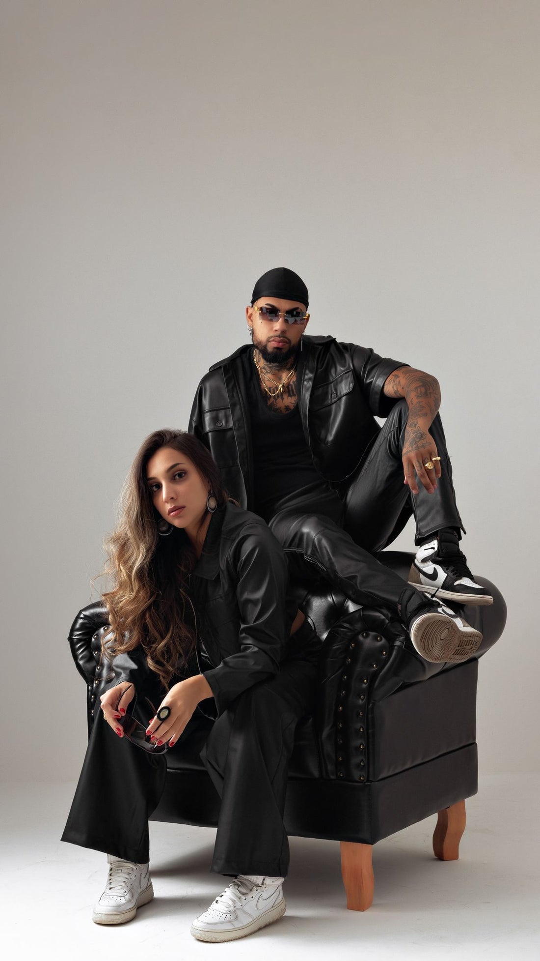 Editorial photo of models in black streetwear with bold jewelry styling