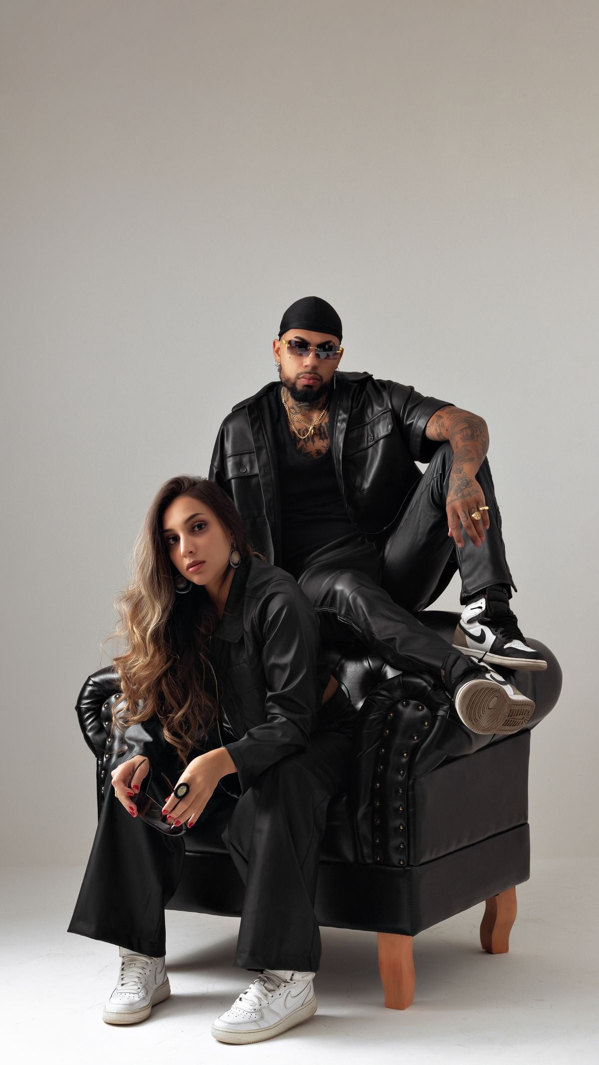 Editorial photo of models in black streetwear with bold jewelry styling