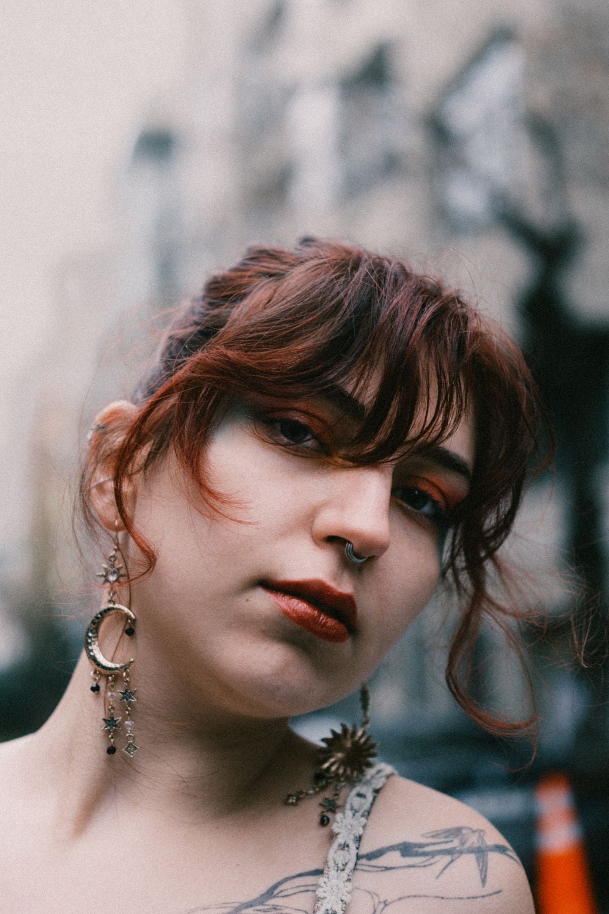 Portrait of a model with bold facial piercings and confident street styling