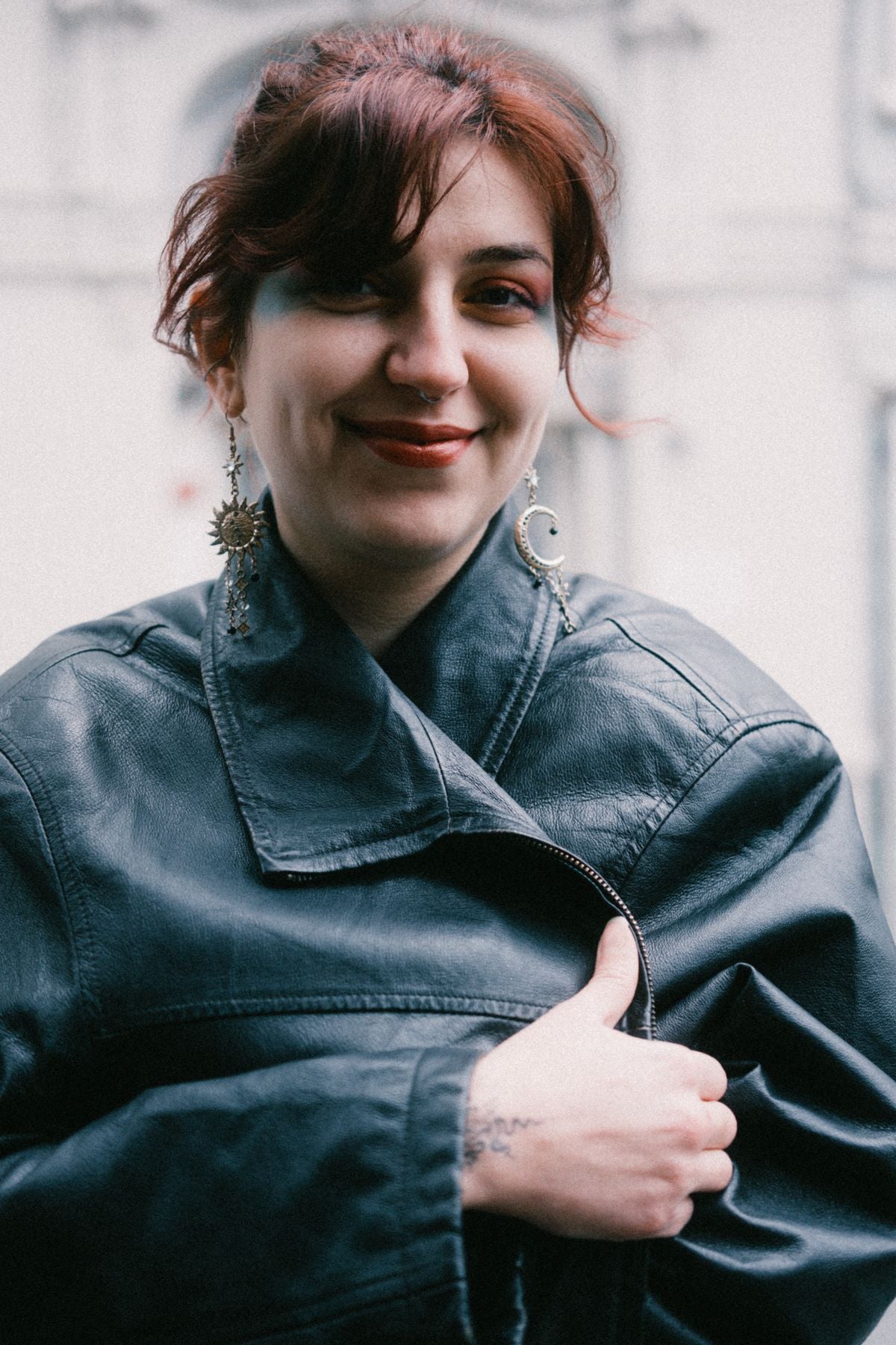 Portrait of a model wearing statement earrings and a confident smile