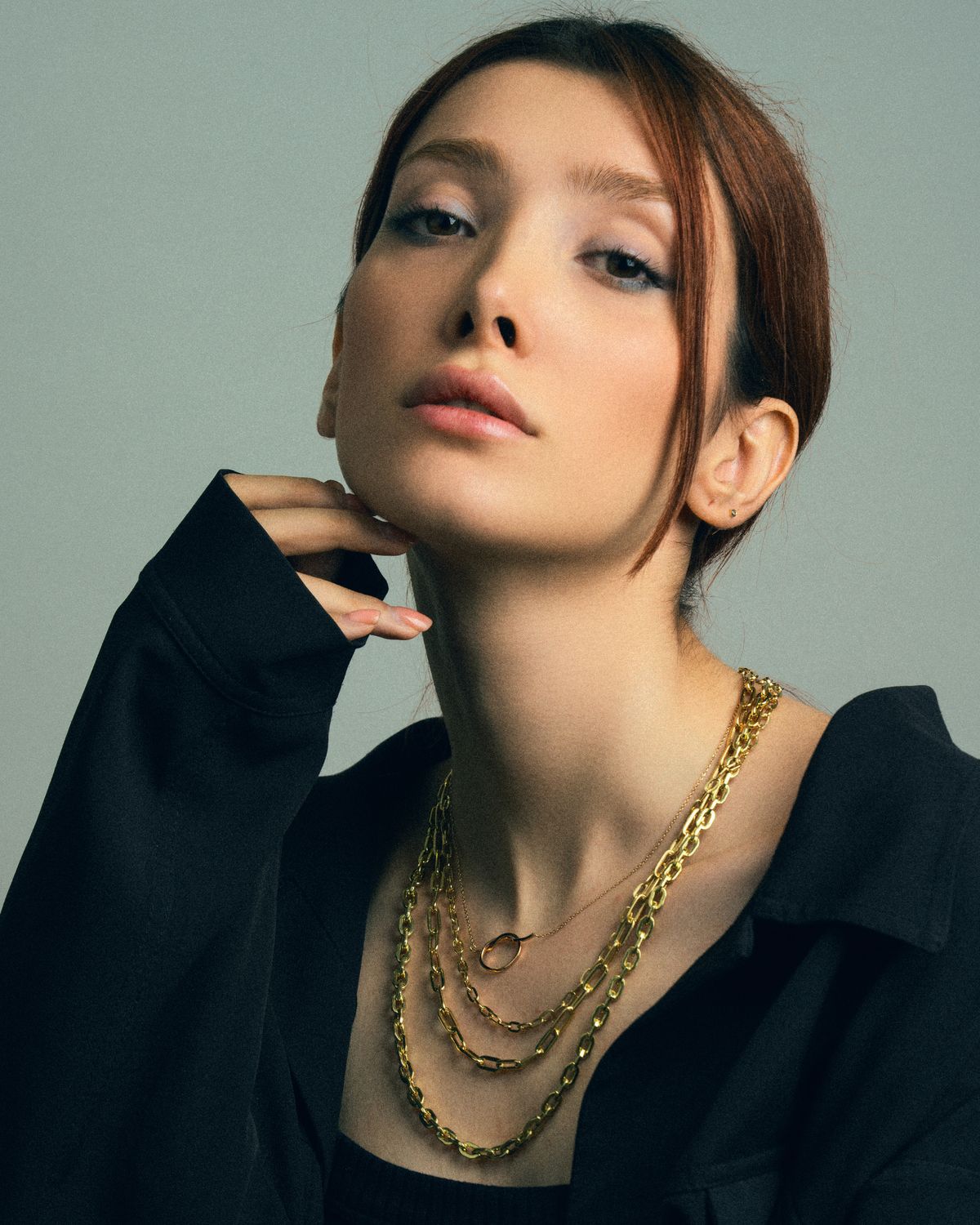 Centered portrait with ivory draping and layered gold necklaces