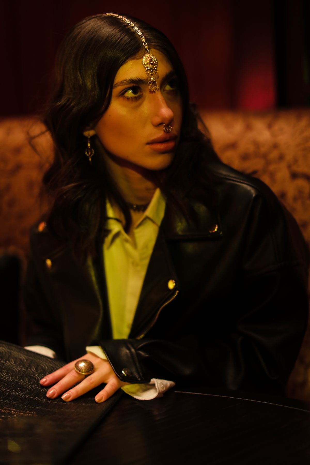 Portrait of a model with a septum piercing and black leather jacket for a punk look
