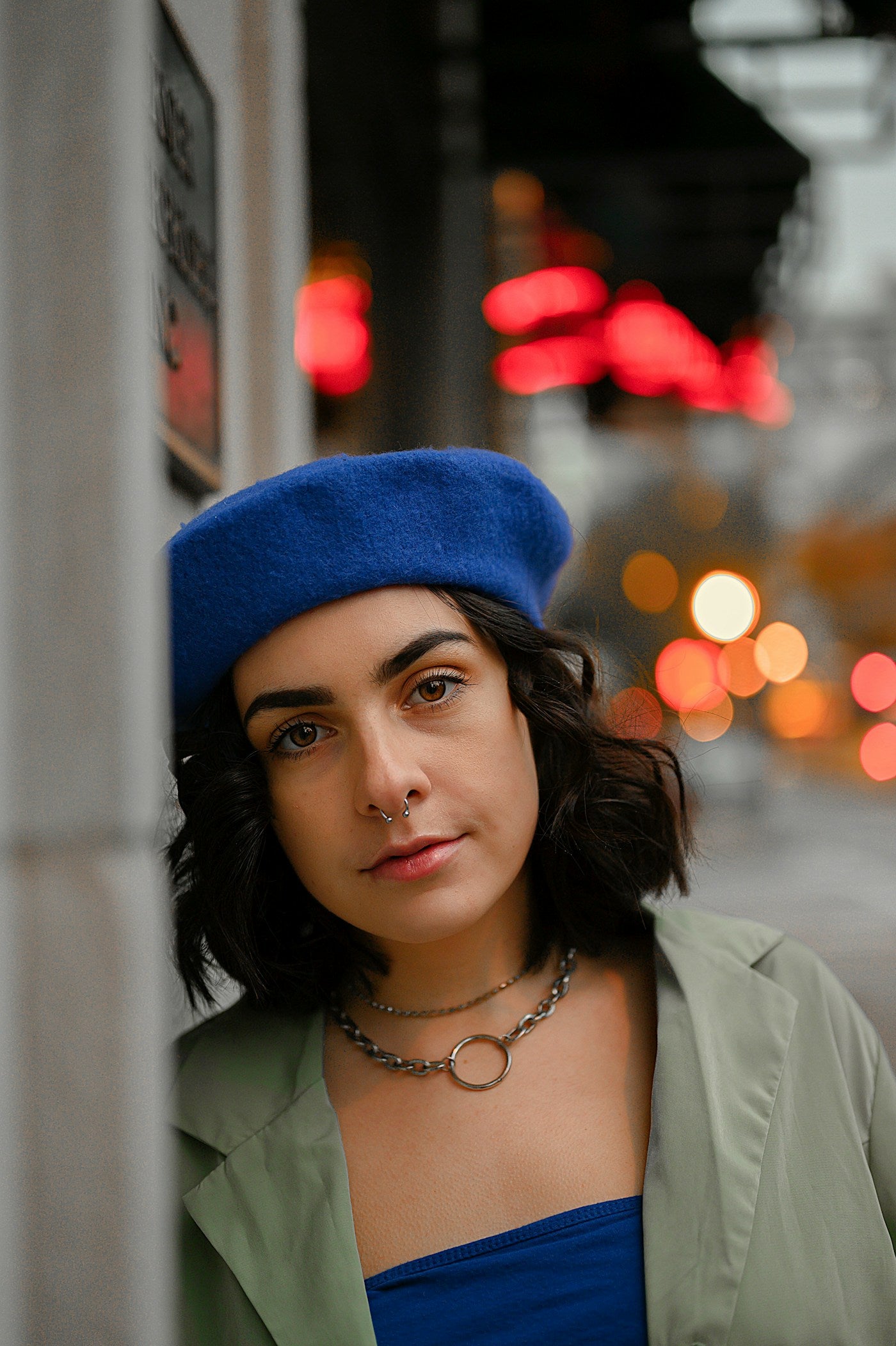 Street-style portrait with blue beret and nose hoop jewelry